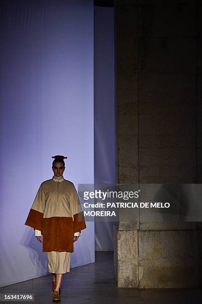 Model displays an outfit by Portuguese designer Alexandra Moura of the Autumn/Winter 2013-2014 collection during the 40th edition of the Moda Lisboa...