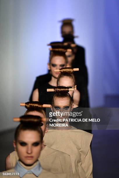 Models display outfits by Portuguese designer Alexandra Moura of the Autumn/Winter 2013-2014 collection during the 40th edition of the Moda Lisboa...