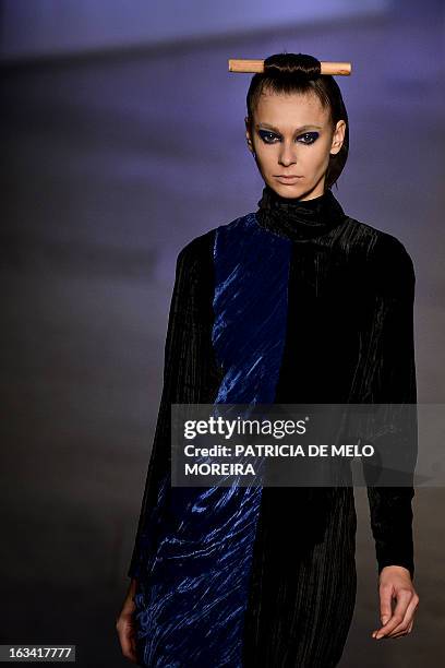 Model displays an outfit by Portuguese designer Alexandra Moura of the Autumn/Winter 2013-2014 collection during the 40th edition of the Moda Lisboa...