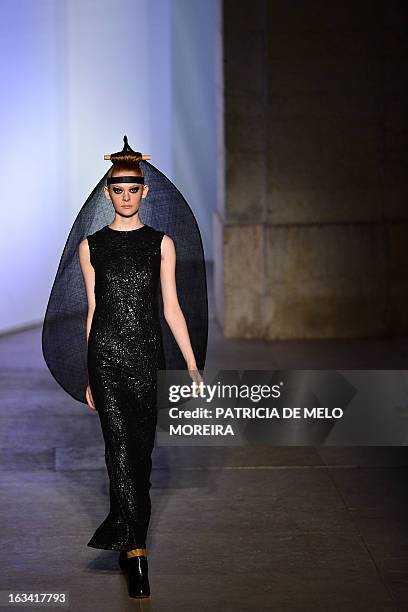 Model displays an outfit by Portuguese designer Alexandra Moura of the Autumn/Winter 2013-2014 collection during the 40th edition of the Moda Lisboa...