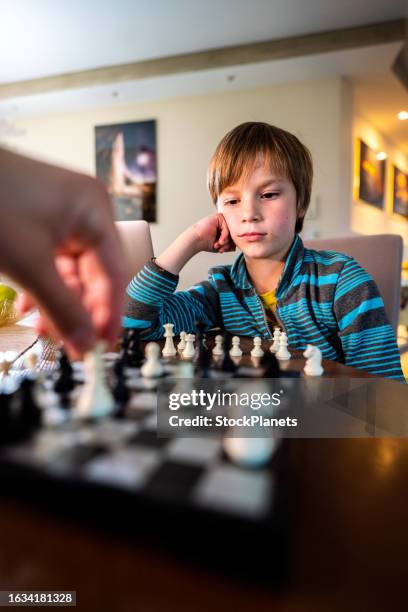 little boy playing chess game - chessmen stock pictures, royalty-free photos & images