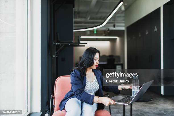 young asian businesswoman working at coworking using laptop - reusable water bottle office stock pictures, royalty-free photos & images