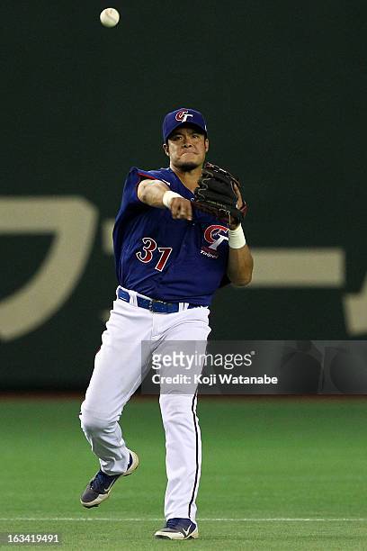 Infielder Chih-Sheng Lin of Chinese Taipei throws during the World Baseball Classic Second Round Pool 1 game between Chinese Taipei and Cuba at Tokyo...