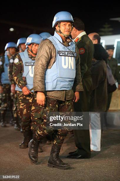 Twenty-one Filipino UN peacekeepers who were held hostage at the free Syrian army in Golan arrive in Amman after crossing into Jordan from Syria on...