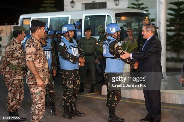 Jordanian Foreign minister Nasser Joudah greets the twenty-one Filipino UN peacekeepers who were held hostage at the free Syrian army in Golan as...