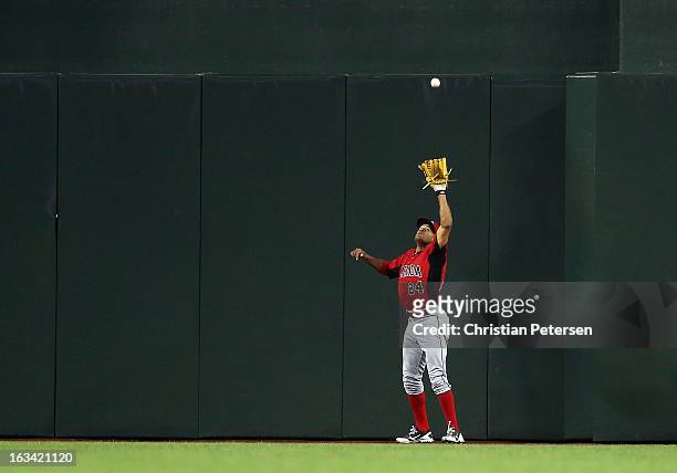 Outfielder Tyson Gillies of Canada catches a fly ball out against Mexico during the World Baseball Classic First Round Group D game at Chase Field on...