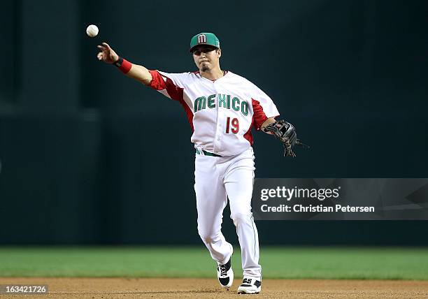 Infielder Ramiro Pena of Mexico fields a ground ball out against Canada during the World Baseball Classic First Round Group D game at Chase Field on...