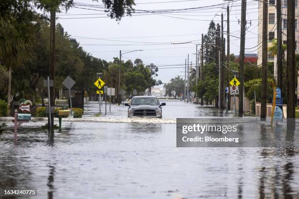 Vehicle moves through a flooded street from Hurricane Idalia in Gulfport, Florida, US, on Wednesday, Aug. 30, 2023. Hurricane Idalia has knocked out...