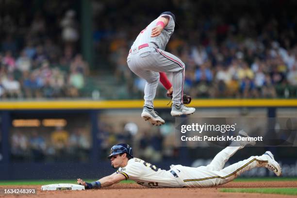 Christian Yelich of the Milwaukee Brewers steals second base against Kyle Farmer of the Minnesota Twins in the first inning at American Family Field...