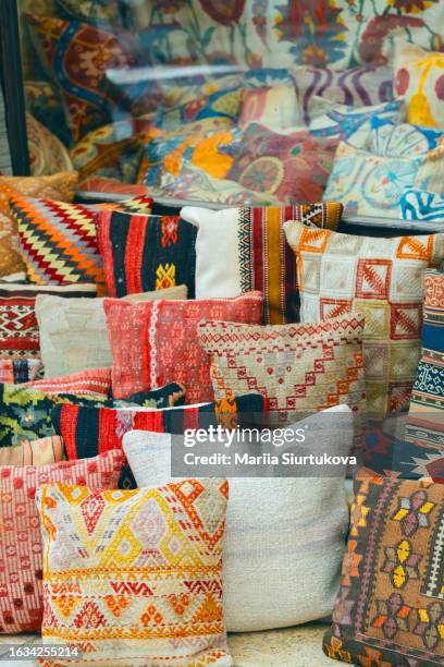 many of traditional turkish decorative pillows on bazar. oriental market vibe - turkish bazar stock pictures, royalty-free photos & images