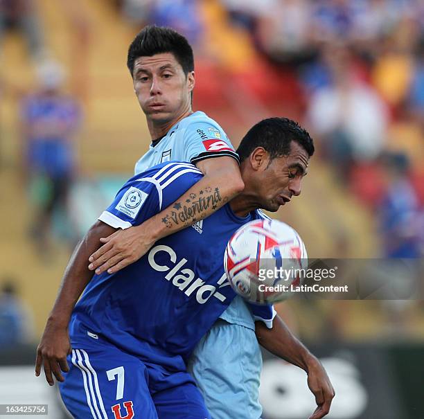 Cesar Cortes of Universidad de Chile struggles for the ball with Rodrigo Brito of Deportes Iquique during a match between Universidad de Chile and...