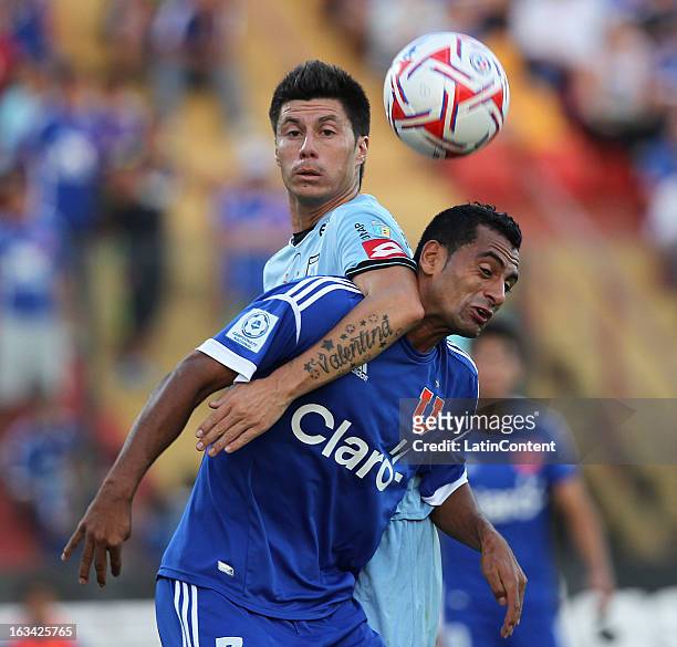 Cesar Cortes of Universidad de Chile struggles for the ball with Rodrigo Brito of Deportes Iquique during a match between Universidad de Chile and...