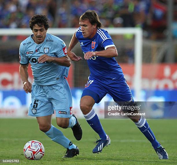 Luciano Cibelli of Universidad de Chile struggles for the ball with Cristian Grabinski of Deportes Iquique during a match between Universidad de...