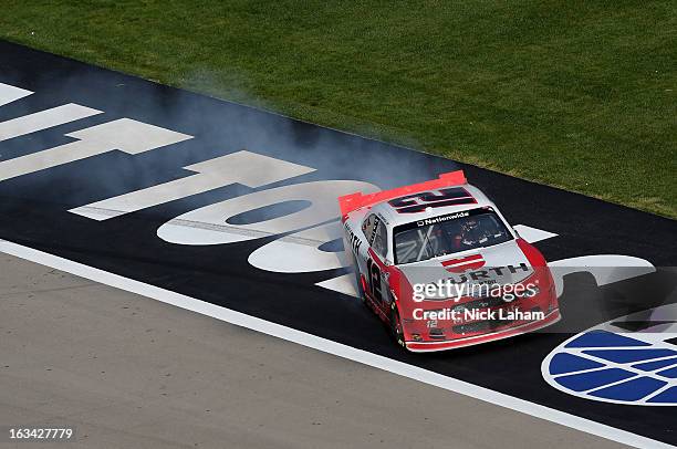 Sam Hornish Jr., driver of the Wurth Ford, celebrates with a burnout after winning the NASCAR Nationwide Series Sam's Town 300 at Las Vegas Motor...