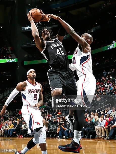 Gerald Wallace of the Brooklyn Nets drives against Johan Petro of the Atlanta Hawks at Philips Arena on March 9, 2013 in Atlanta, Georgia. NOTE TO...