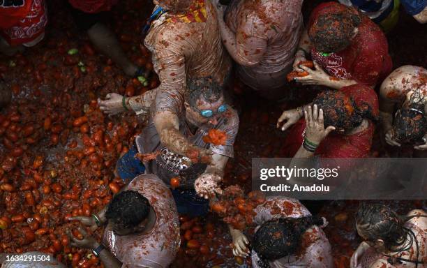 People covered in tomato pulp take part in the 76th 'Tomatina' Festival in the eastern town of Bunol, Spain on August 30, 2023. Approximately 15,000...
