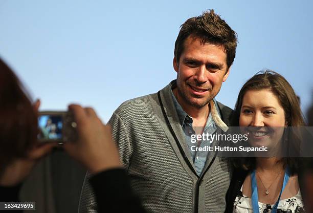 Actor Alexis Denisof poses with a fan at the Much Ado About Much Ado Panel during the 2013 SXSW Music, Film + Interactive Festival at Austin...