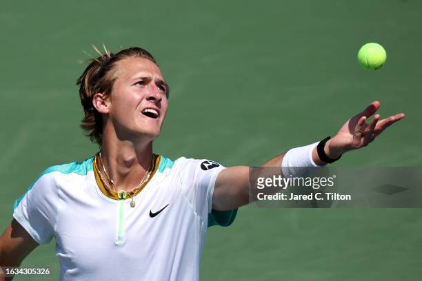 Sebastian Korda of the United States serves to Marton Fucsovics of Hungary during their third round match of the Winston-Salem Open at Wake Forest...