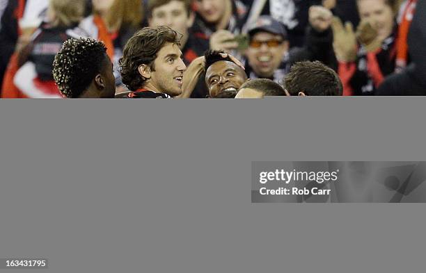 Lionard Pajoy of D.C. United is mobbed by teammates after scoring a second half goal against the Real Salt Lake at RFK Stadium on March 9, 2013 in...