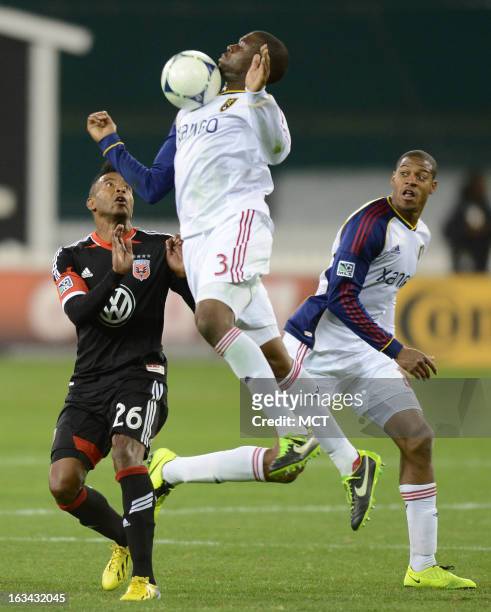 Real Salt Lake defender Tony Beltran makes a play on the ball with his chest over D.C. United forward Lionard Pajoy and Real Salt Lake defender Chris...