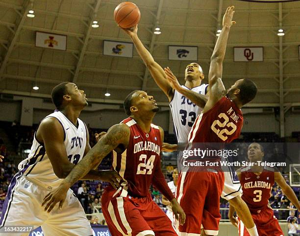 Texas Christian's Garlon Green goes up over Oklahoma's Romero Osby and Amath M'Baye in the second half at Daniel-Meyer Coliseum in Fort Worth, Texas,...