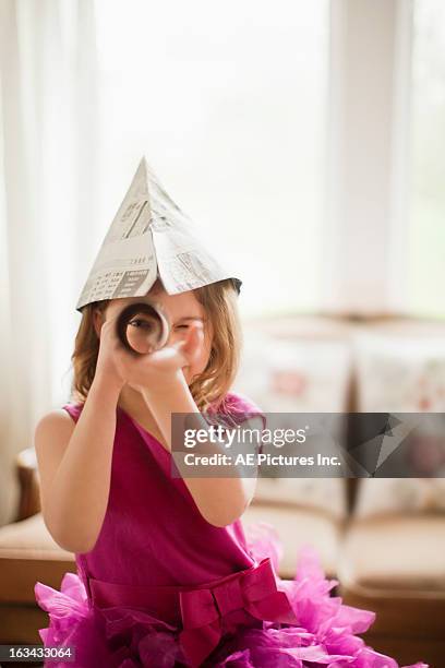 young girl with a telescope - mensch fernrohr stock-fotos und bilder