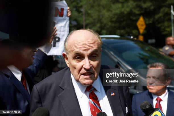 Rudy Giuliani speaks to the media after leaving the Fulton County jail on August 23, 2023 in Atlanta, Georgia. Giuliani is one of 19, including...