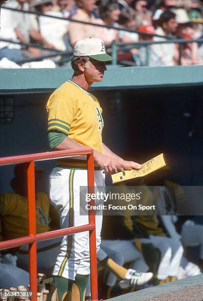 Manager Chuck Tanner of the Oakland Athletics looks on from the steps of the dugout during an Major League Baseball game against the Minnesota Twins...