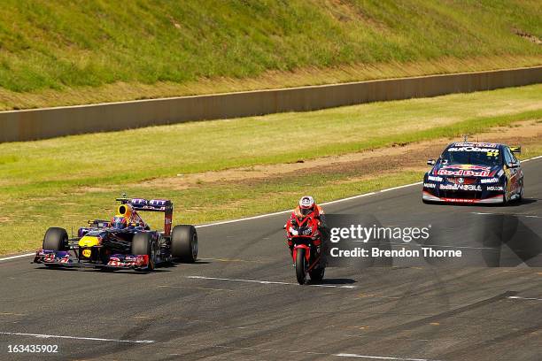 Mark Webber of Australia and Infiniti Red Bull Racing, Casey Stoner of Red Bull Pirtek Holden and Jamie Whincup of Red Bull Racing Australia Holden...