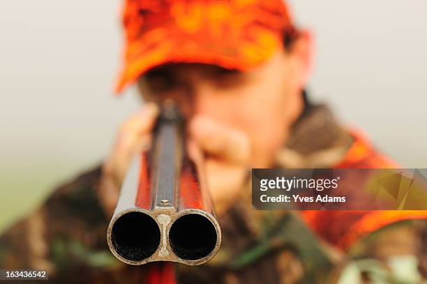 close up of a hunter aiming his shotgun - rifle fotografías e imágenes de stock