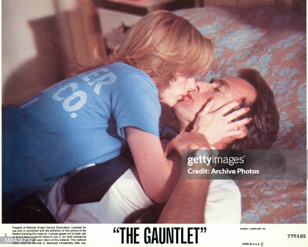 Sondra Locke kissing Clint Eastwood on the bed in a scene from the film 'The Gauntlet', 1977.