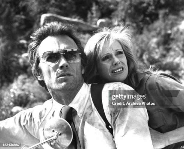 Clint Eastwood and Sondra Locke looking from motor bike in a scene from the film 'The Gauntlet', 1977.