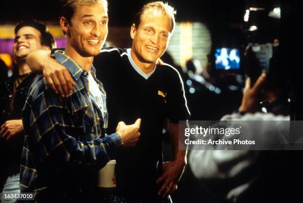 Matthew McConaughey and Woody Harrelson smiling before the camera in a scene from the film 'Edtv', 1999.