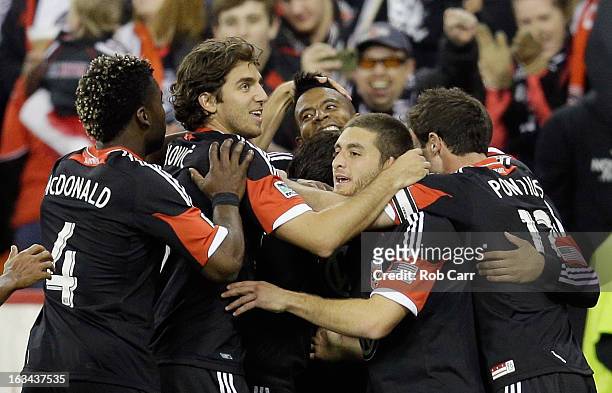 Lionard Pajoy of D.C. United is mobbed by teammates after scoring a second half goal against the Real Salt Lake at RFK Stadium on March 9, 2013 in...