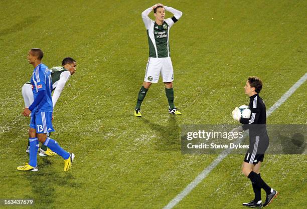 Will Johnson of Portland Timbers puts his hands on his head as Troy Perkins of Montreal Impact holds the ball as time winds down during the second...