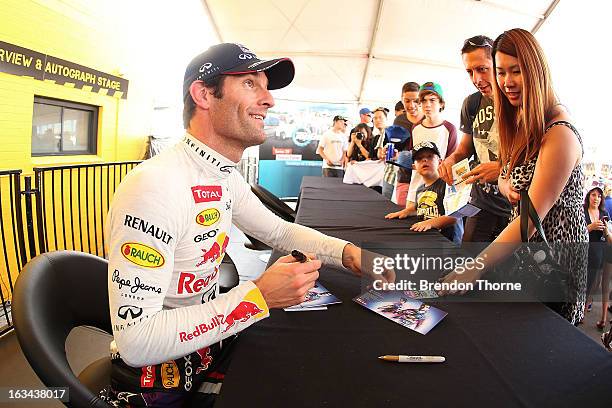 Mark Webber of Australia and Infiniti Red Bull Racing signs autographs for fans during the Top Gear Festival at Sydney Motorsport Park on March 10,...