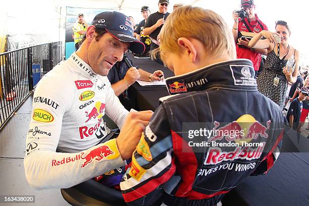 Mark Webber of Australia and Infiniti Red Bull Racing signs autographs for fans during the Top Gear Festival at Sydney Motorsport Park on March 10,...