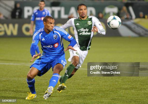Matteo Ferrari of Montreal Impact and Ryan Johnson of Portland Timbers go after a ball during the second half of the game at Jeld-Wen Field on March...