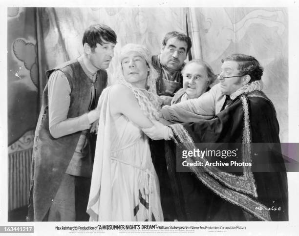 Joe E Brown being grabbed by group men in a scene from the film 'A Midsummer Night's Dream', 1935.