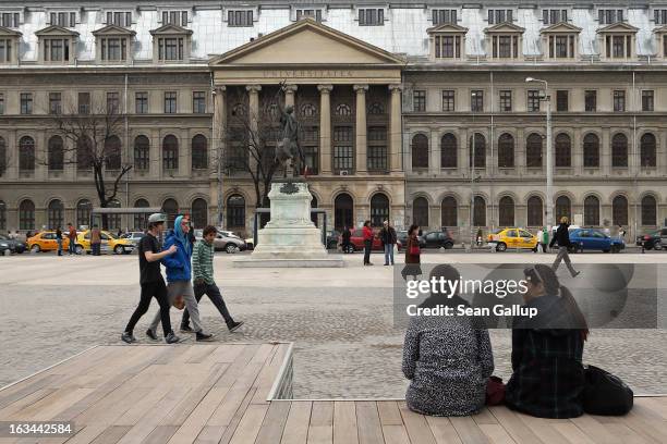 Students relax outside the main university on March 8, 2013 in Bucharest, Romania. Both Romania and Bulgaria have been members of the European Union...