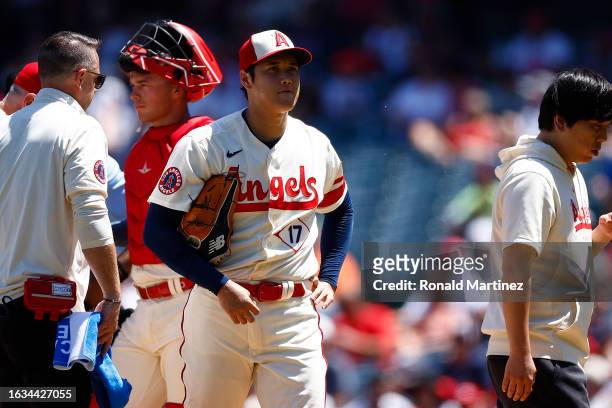 Shohei Ohtani of the Los Angeles Angels leaves the game against the Cincinnati Reds in the second inning during game one of a doubleheader at Angel...