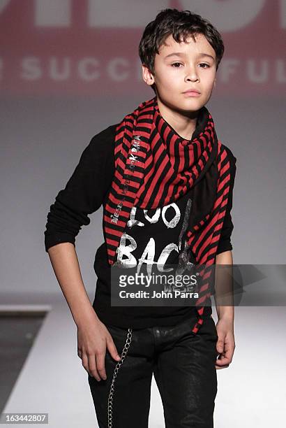 Model walks the runway in the Diesel Kids fashion show during 2013 petitePARADE Kids Fashion Week at Industria Superstudio on March 9, 2013 in New...