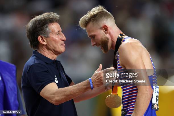 Josh Kerr of Team Great Britain is awarded the gold medal for the Men's 1500m Final by Sebastian Coe, President of World Athletics, during day five...