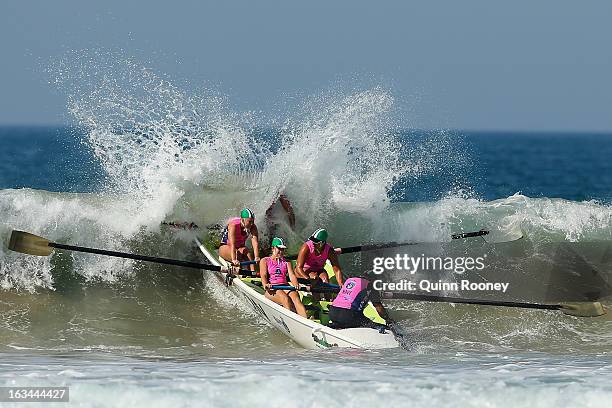 The crew from Woolamai Beach crash through a wave in the surf boat race during the Victorian Surf Lifesaving Championships on March 10, 2013 in...