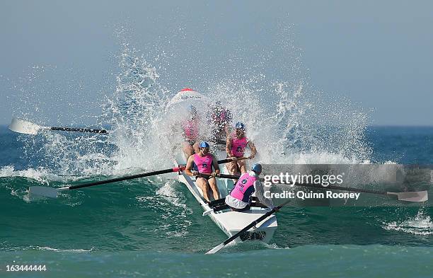 The crew from St Kilda crash through a wave in the surf boat race during the Victorian Surf Lifesaving Championships on March 10, 2013 in Anglesea,...