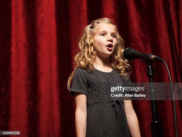 usa, utah, orem, portrait of girl (8-9) singing with microphone - girl stage stock pictures, royalty-free photos & images