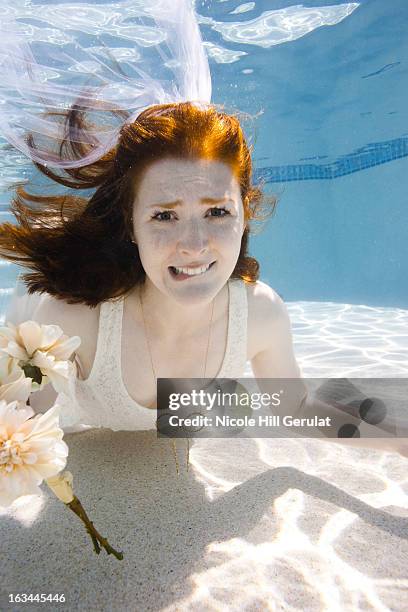 usa, utah, orem, portrait of young bride with bouquet under water - bride underwater stock pictures, royalty-free photos & images