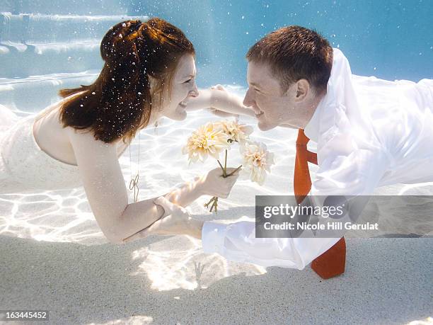 usa, utah, orem, wedding couple under water - bride underwater stock pictures, royalty-free photos & images