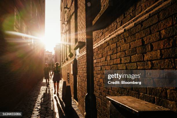 The sun sets over an alleyway in a residential area of the Stoke Newington district of London, UK, on Tuesday, Aug. 22, 2023. Heat waves in the...