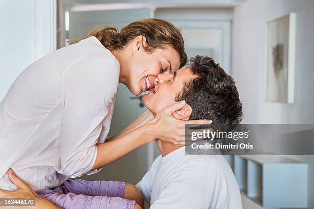 couple smiling and about to kiss passionately - enamorarse fotografías e imágenes de stock